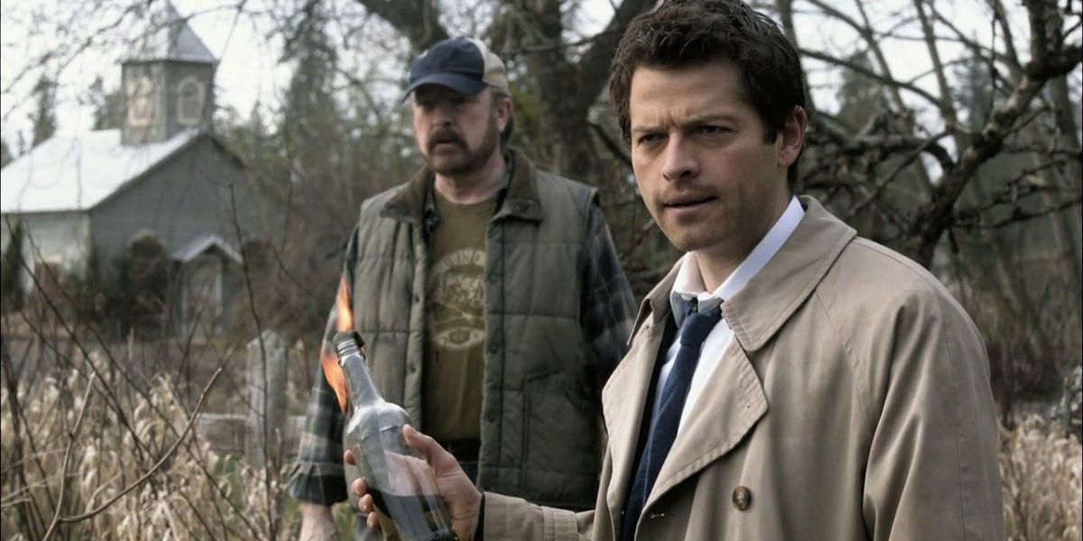 Castiel holds molotov cocktail, bobby stands in background