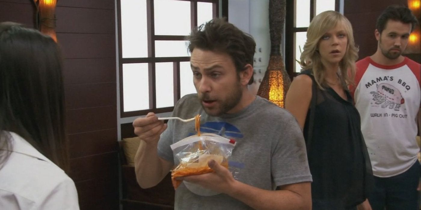 Charlie eating spaghetti as Dee and Mac watch in It's Always Sunny in Philadelphia.