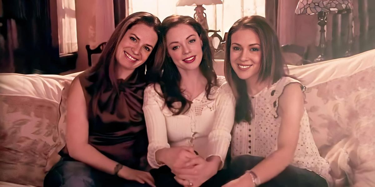 Piper, Paige, and Phoebe sit together on the couch in the Charmed finale
