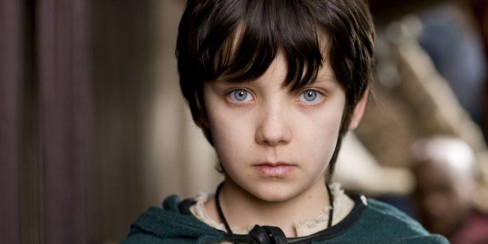 Close up of Asa Butterfield wearing a cape in Merlin