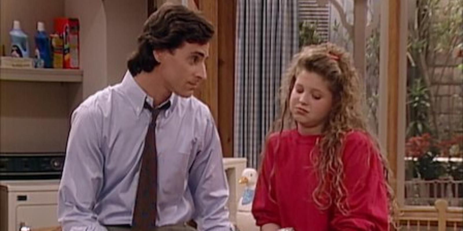 Danny Tanner and DJ Tanner sit on the counter in the kitchen in Full House