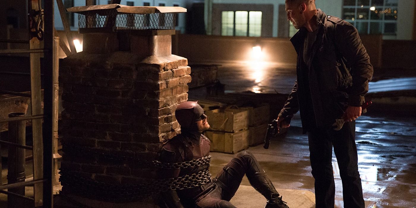 Production still of Daredevil chained up by the Punisher in season 2