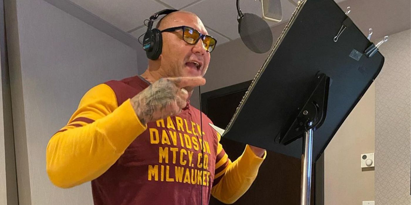 Dave Bautista speaking into a microphone in a studio recording session