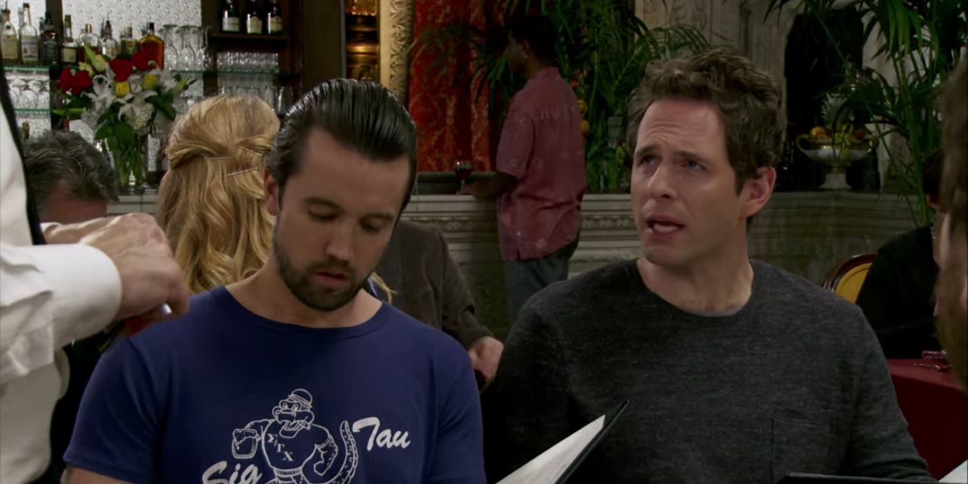 Dennis looking irritated next to Mac in It's Always Sunny in Philadelphia.