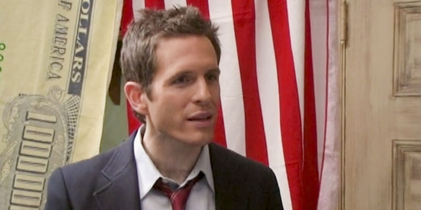 Dennis stands in front of the American flag in It's Always Sunny in Philadelphia.