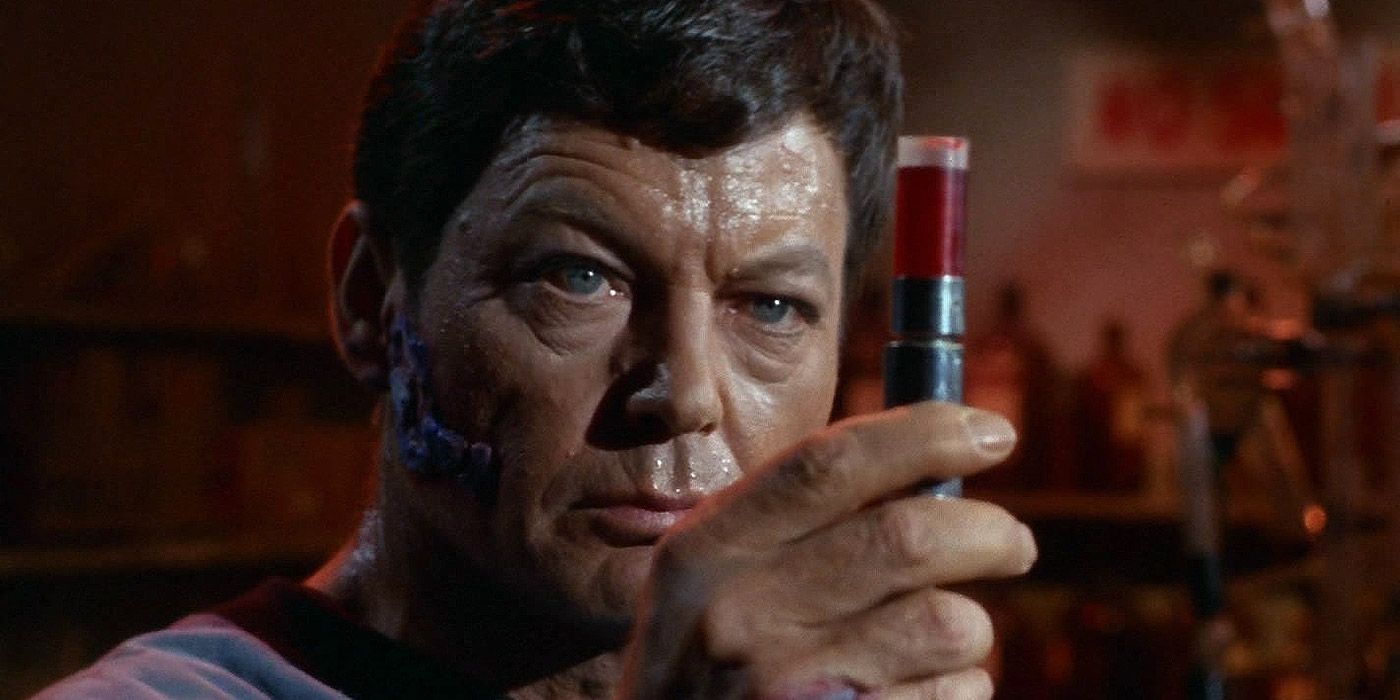 A sick Dr. McCoy holding a vial from Star Trek