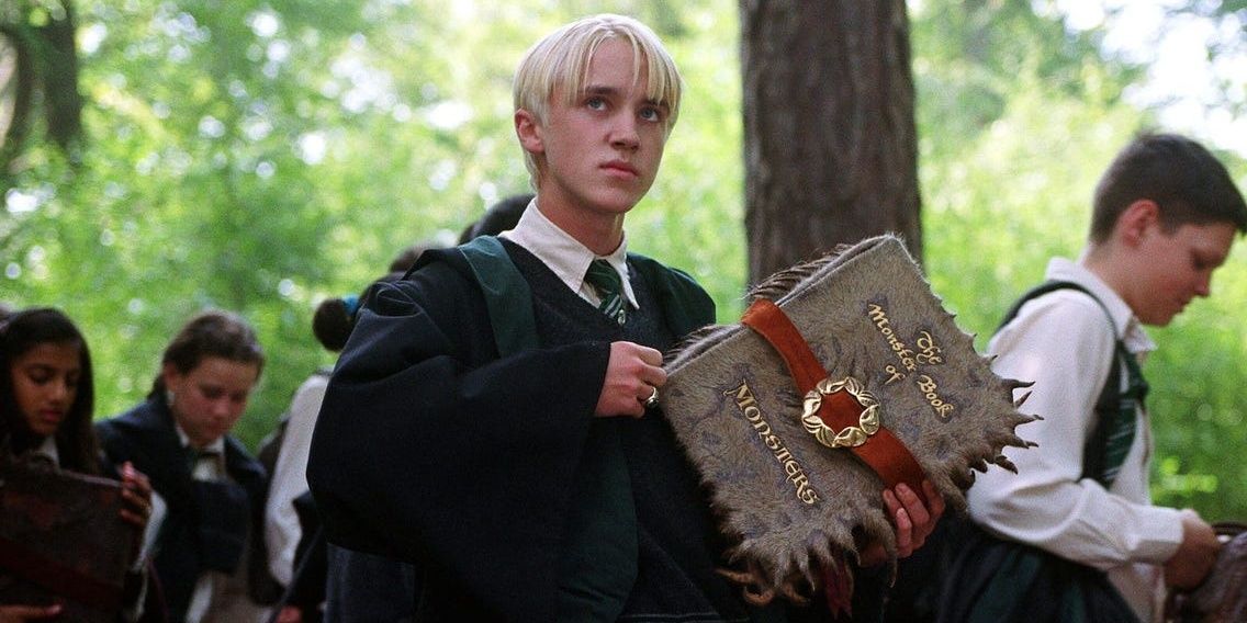 Draco Malfoy with a magical book in Harry Potter and the Prisoner of Azkaban
