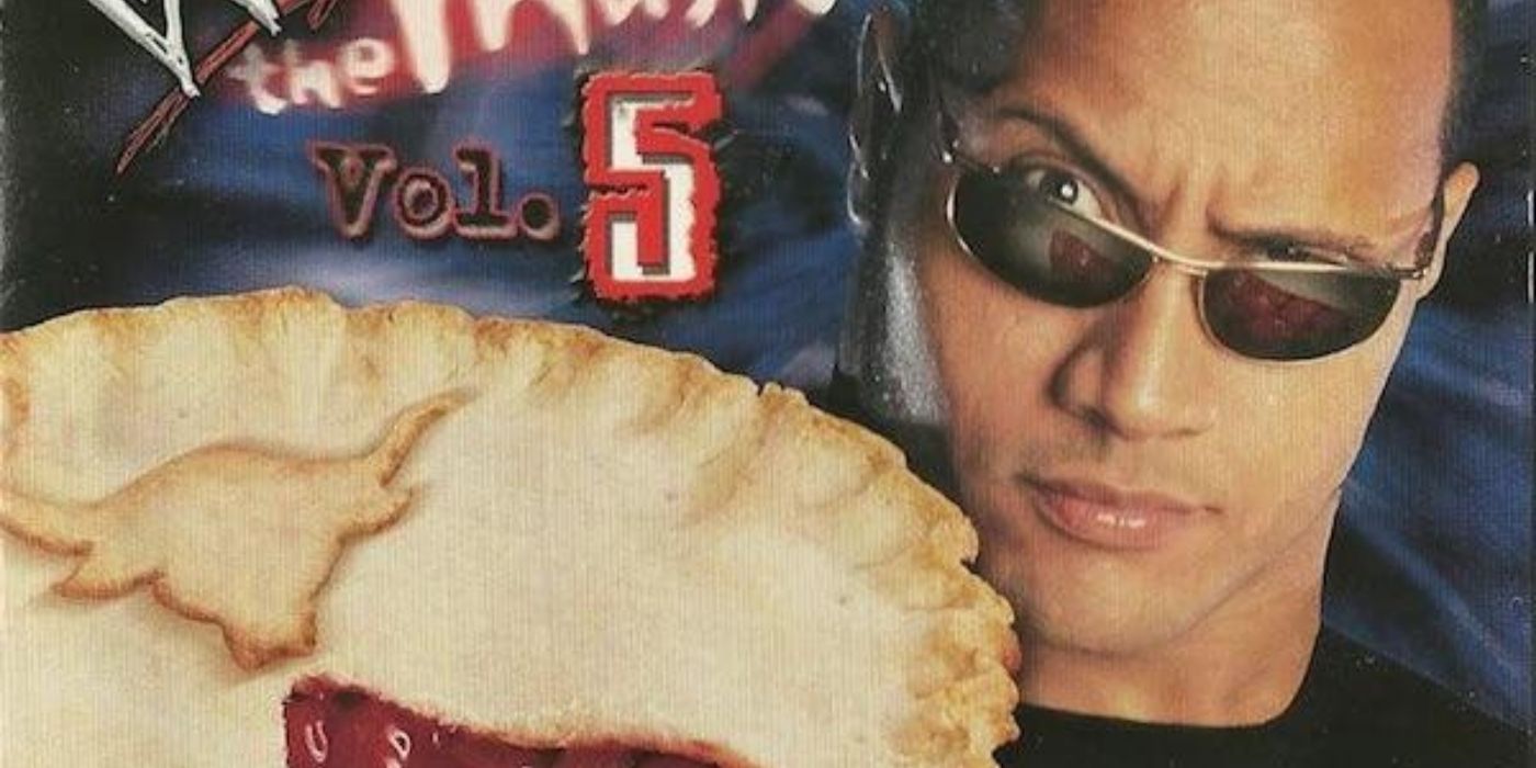Dwayne Johnson raising an eyebrow and holding a pie on the cover of WWE The Music Vol 5