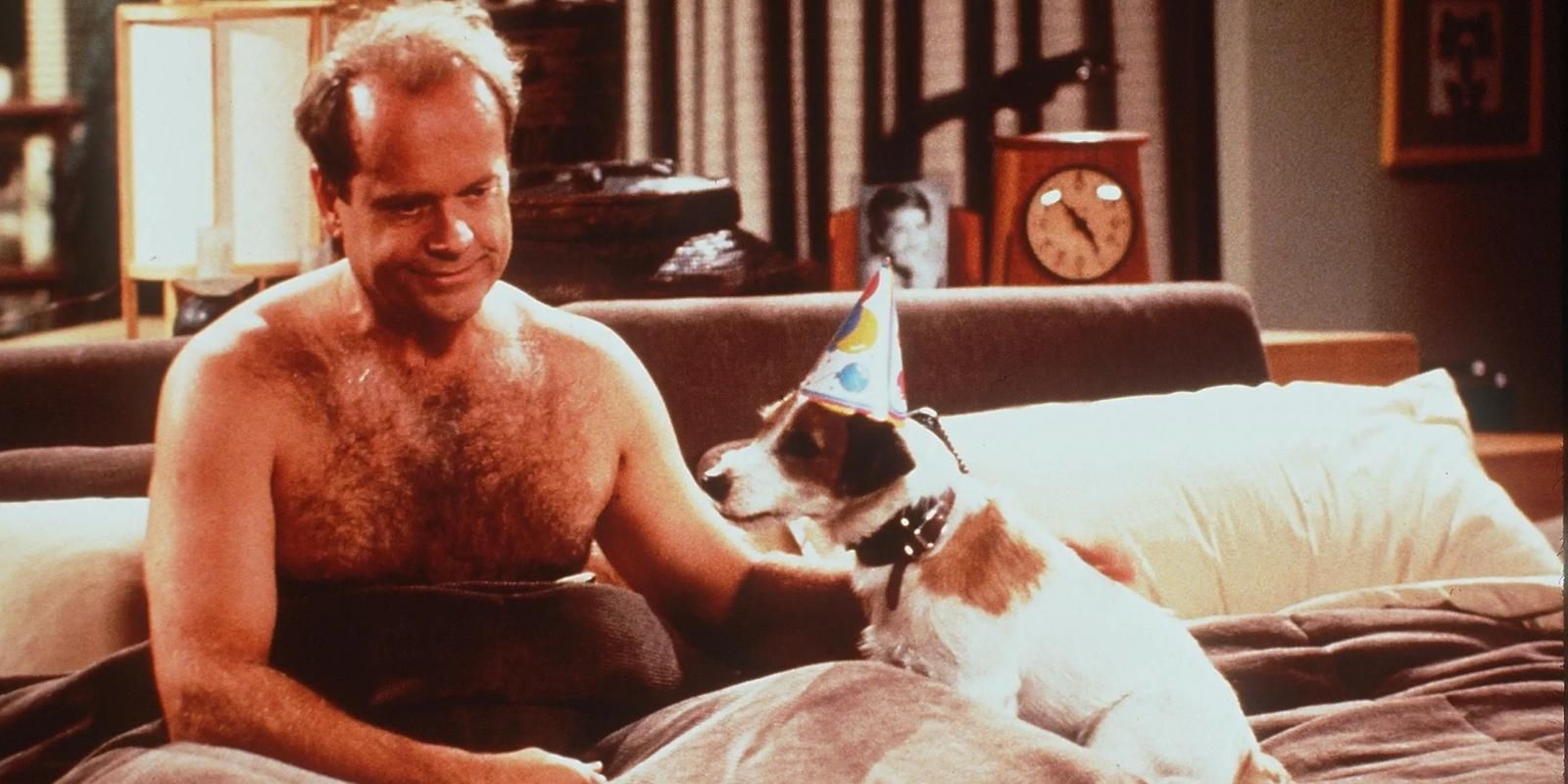 Eddie the dog wearing a birthday hat in bed wih Frasier Crane in Frasier