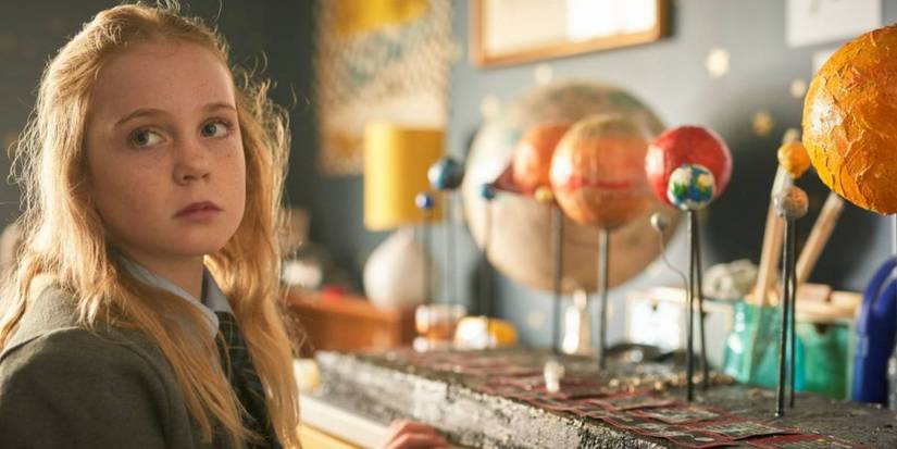 Emma (Ariel Donoghue) looks at her science project in Wolf Like Me