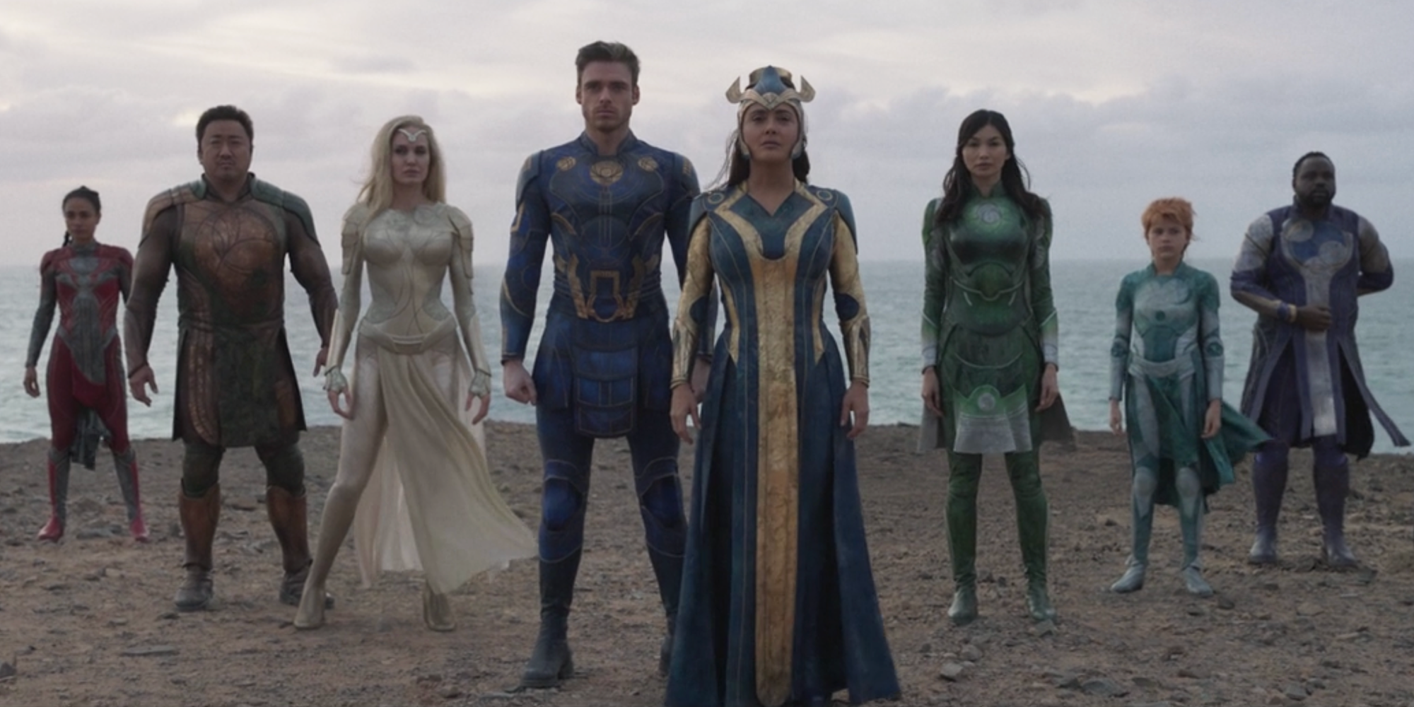 Eternals characters standing together on a beach 