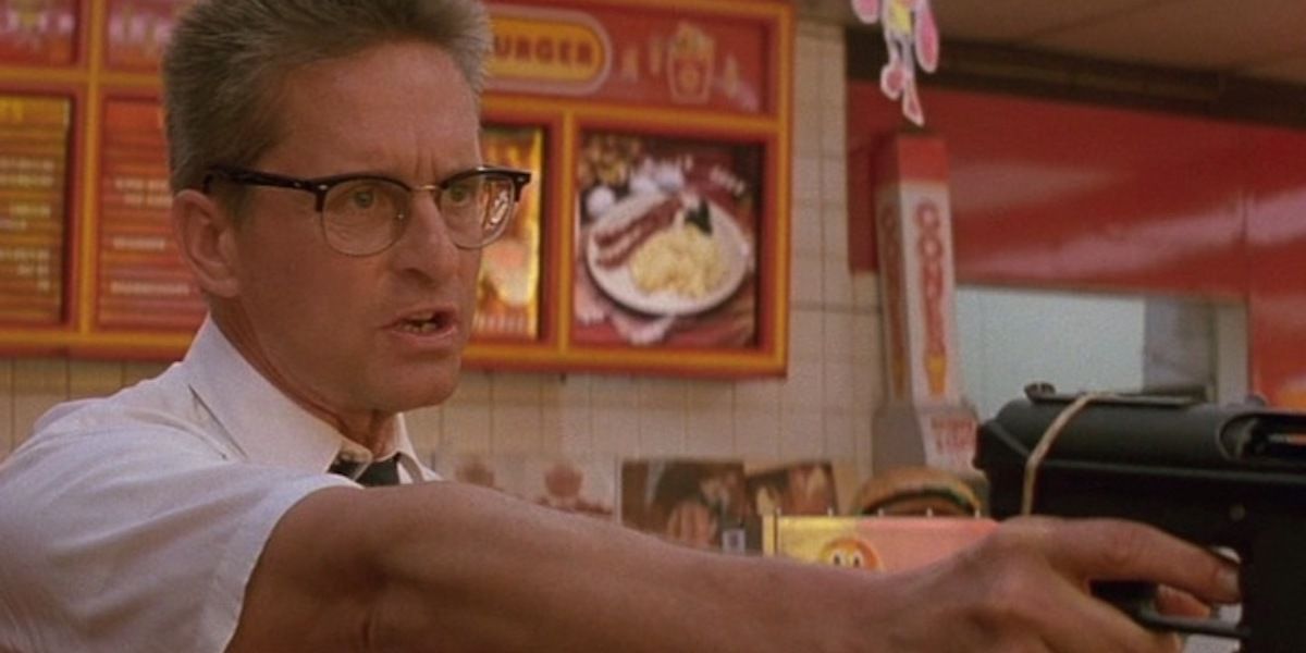Still image of Michael Douglas holding a gun in a fast food restaurant in Falling Down