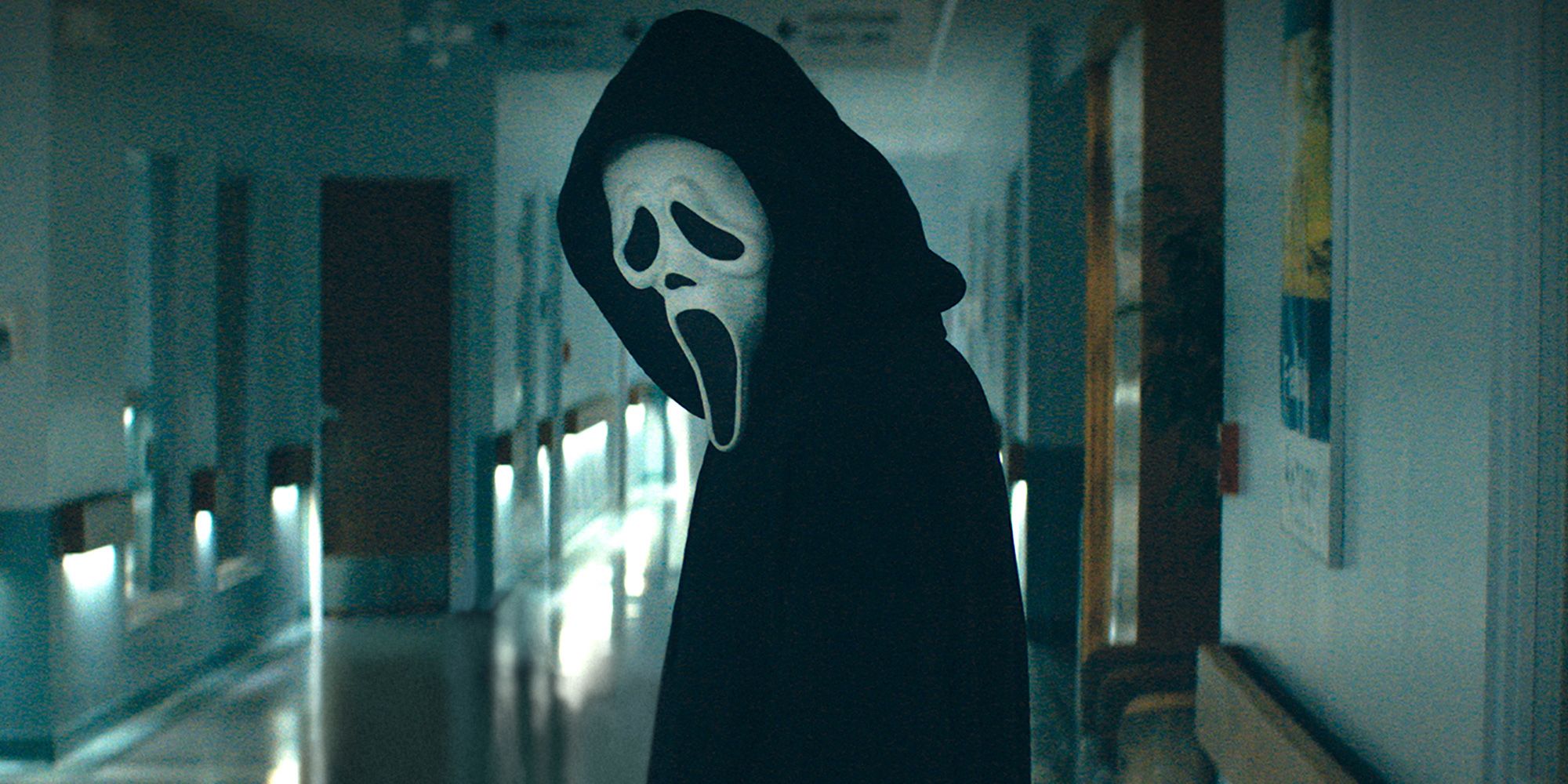 Ghostface stands still in a hallway in Scream 5 2022