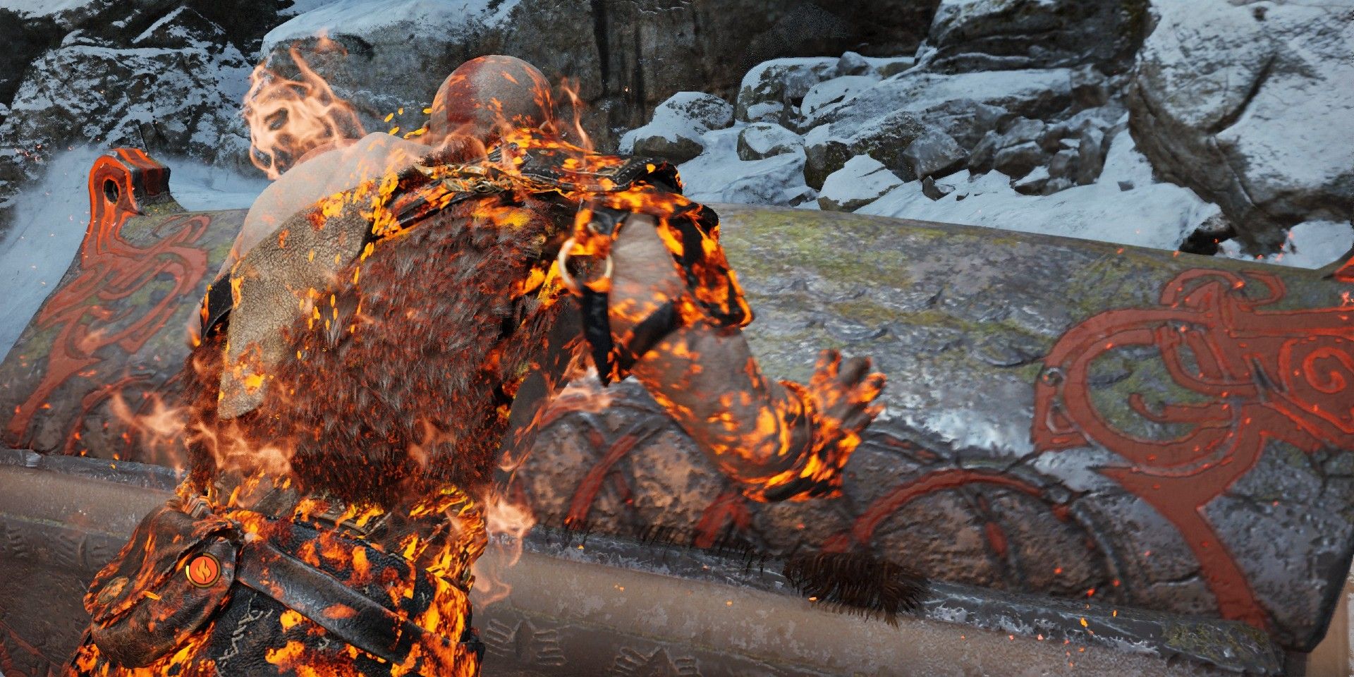 Kratos in God of War consumed by fire and opening a chest at the same time