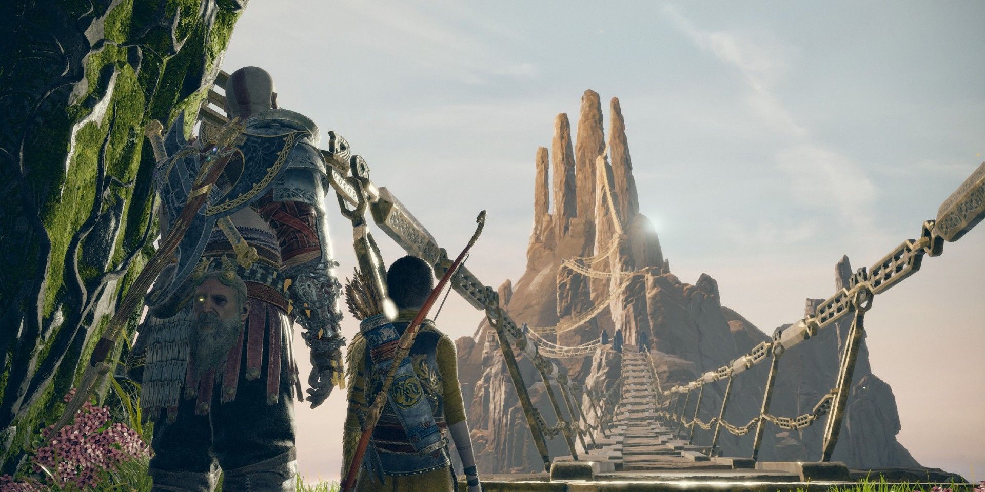 Kratos and Atreus staring at a tall mountain at the end of a very long bridge in God of War