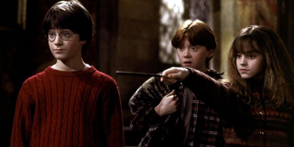 Hermione casting a spell as Ron and Harry look on