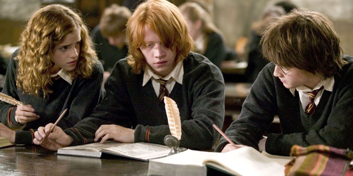Hermione frowning at Ron and Harry who are studying in Harry Potter