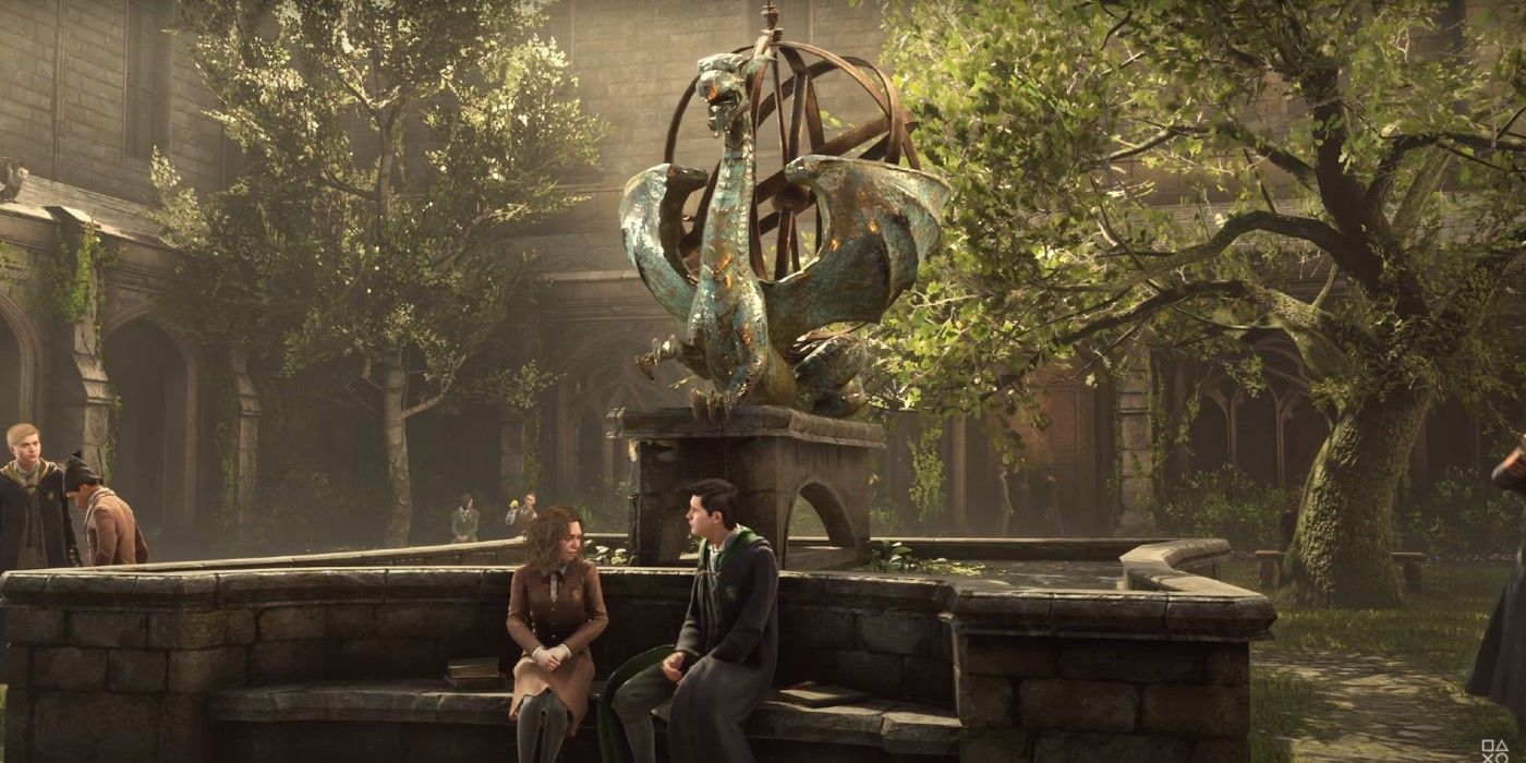 Two students in Hogwarts Legacy are sitting on a bench in a courtyard underneath a stone statue of a dragon