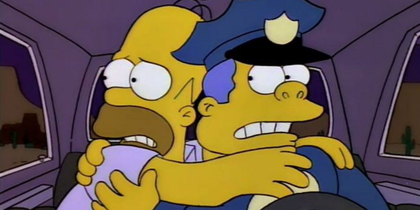 Homer and Chief Wiggum clutch each other in fear in The Simpsons