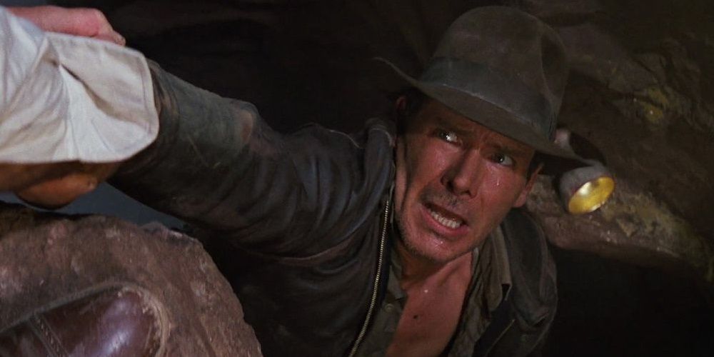 Indy reaching for the Holy Grail in Indiana Jones and the Last Crusade