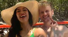 90 Day Fiancé's Jesse Meester smiling Jeniffer Tarazona wearing beach hat laughing