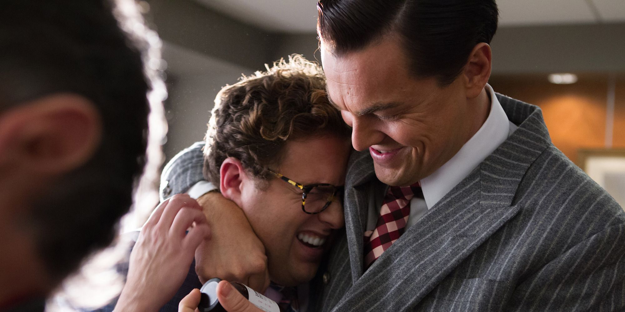 Jonah Hill and Leonardo DiCaprio hug in The Wolf of Wall Street