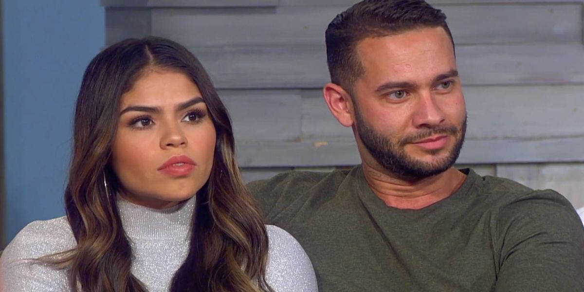 Jonathan and Fernanda sitting side by side and looking in the same direction in 90 Day Fiance.