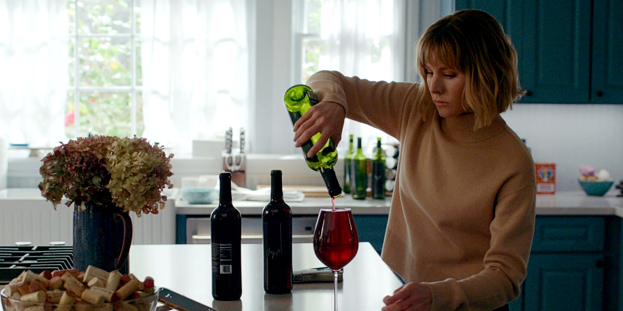 Anna pouring wine in The Woman in the House.