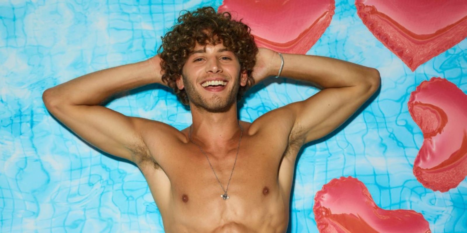 Love Island Eyal Booker floating in a pool with heart floats