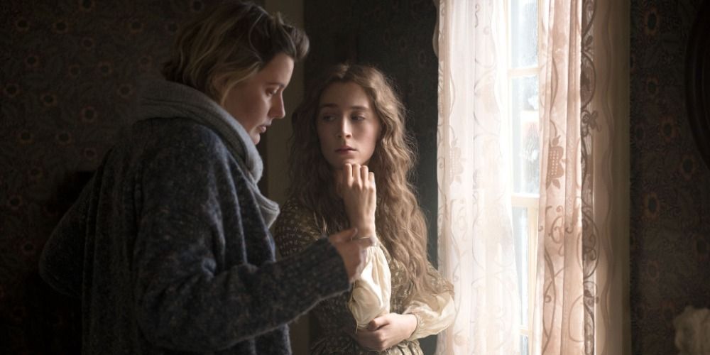 An image of Greta Gerwig and Saoirse Ronan behind the scenes of Little Women.