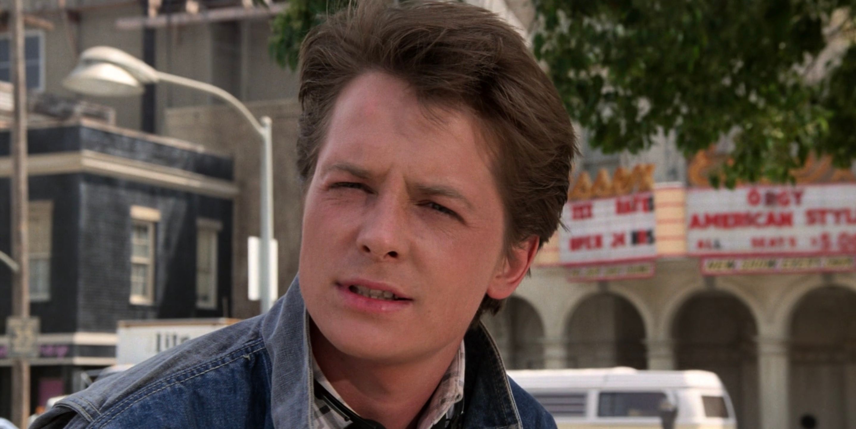 Marty McFly shot with Orgy American Style on theater marquee in the background