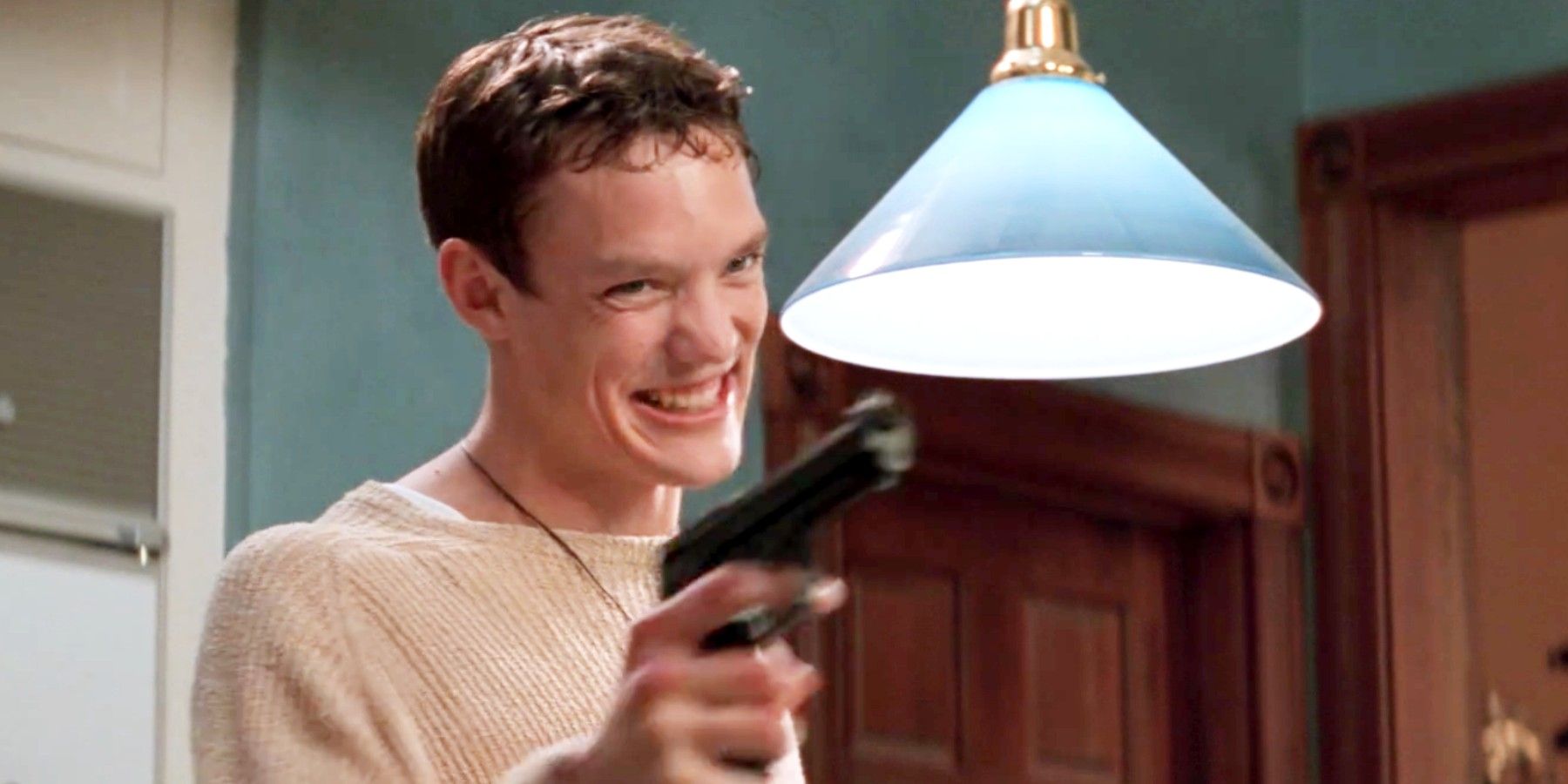 Stu pointing a gun while laughing in in Scream