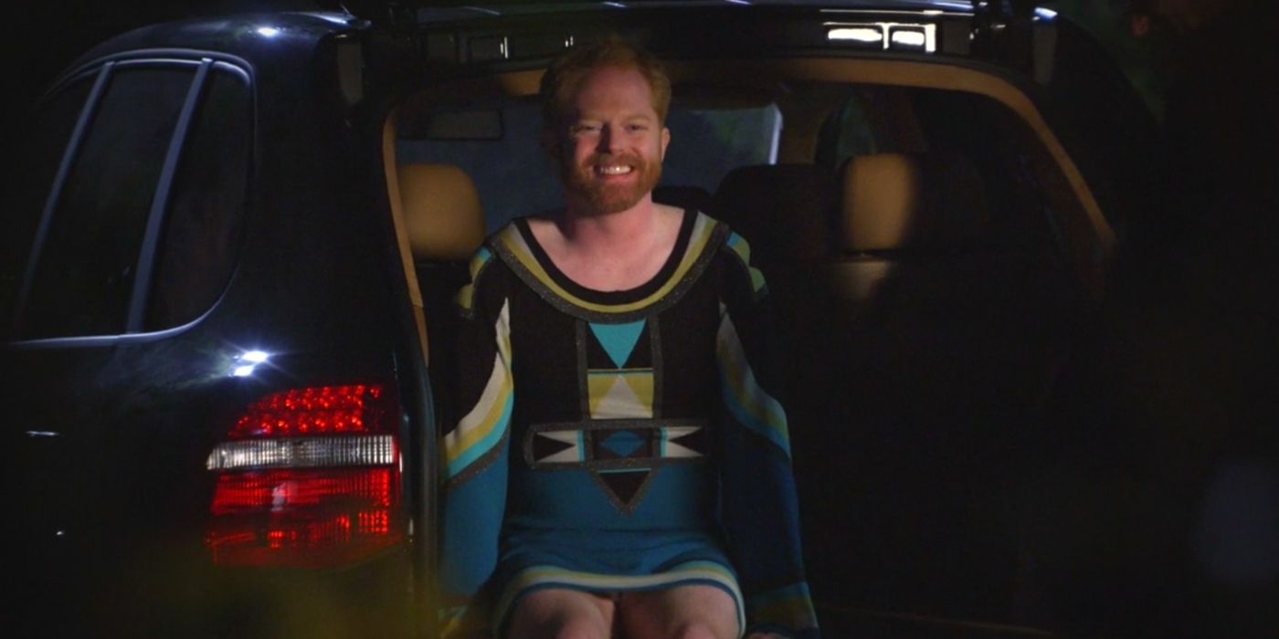 Mitchell smiling in a dress on Modern Family