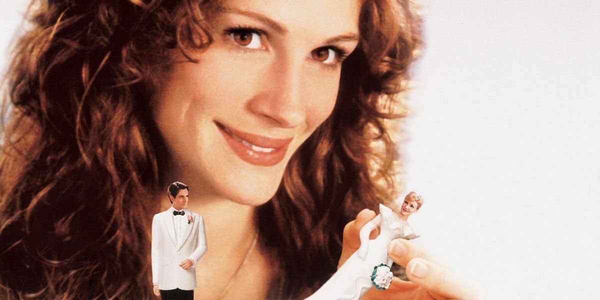 Poster for My Best Friend's Wedding showing Julia Roberts removing the bride from a wedding cake