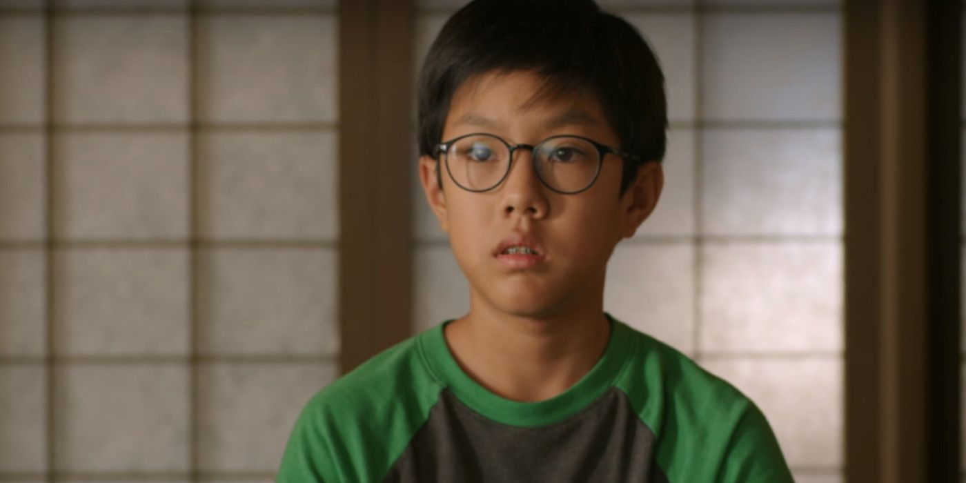 Nathaniel from Cobra Kai wearing glasses and a green T-shirt.
