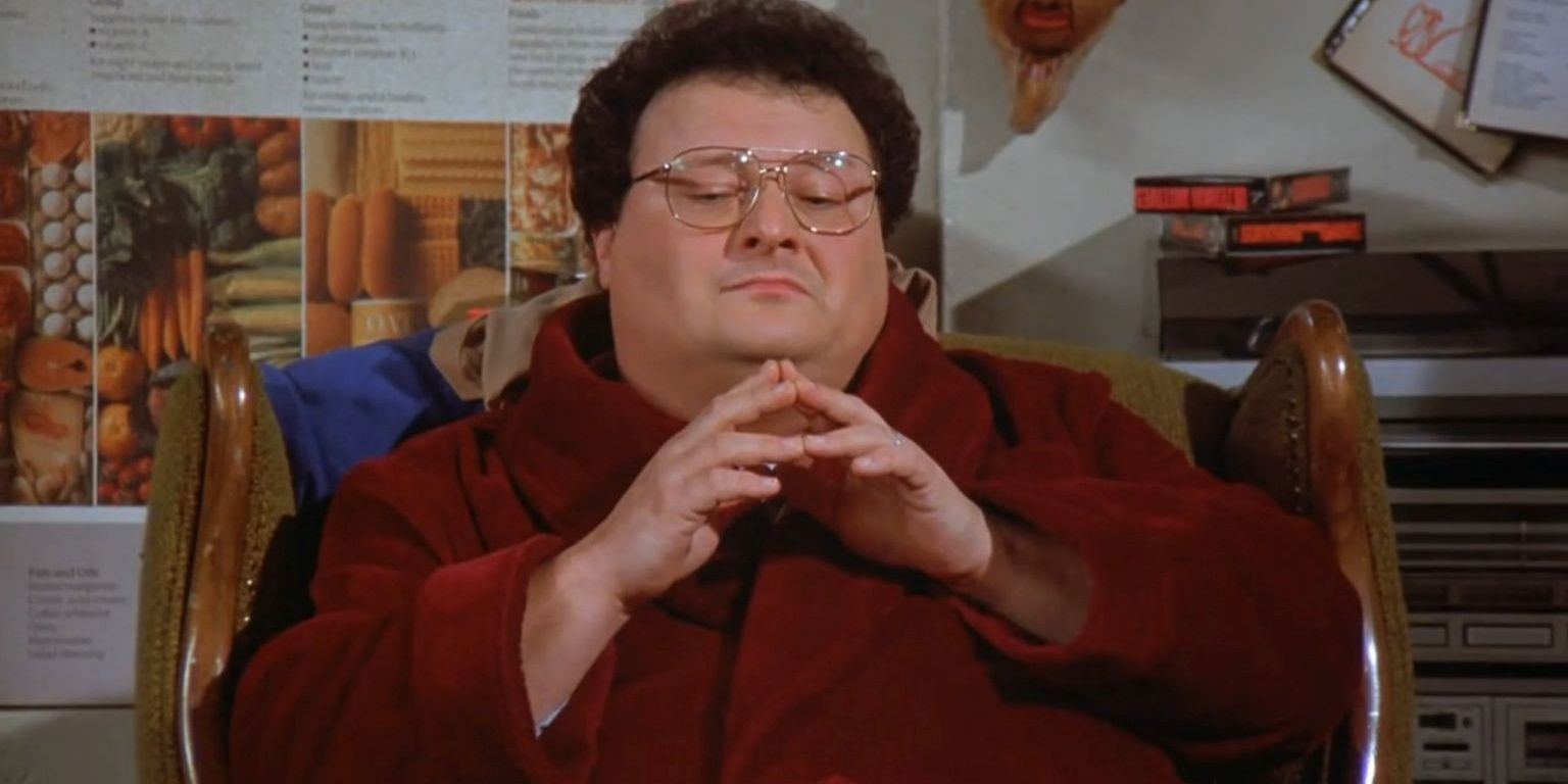 Newman sits on his couch in Seinfeld