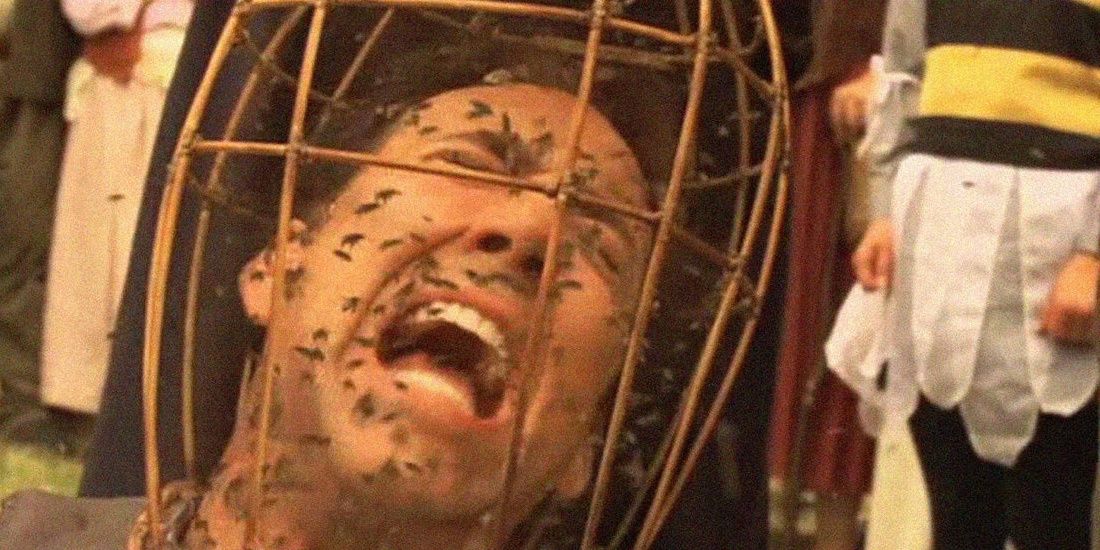Nicolas Cage screaming as a basket of bees covers his head in The Wicker Man