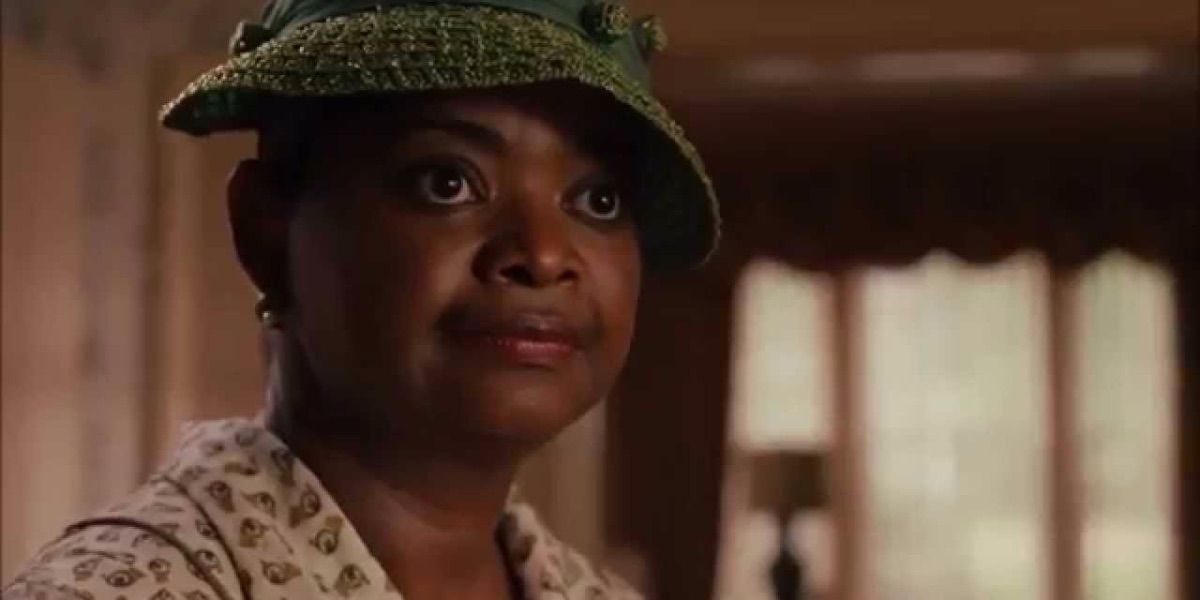 Octavia Spencer looks on in a green hat from The Help 