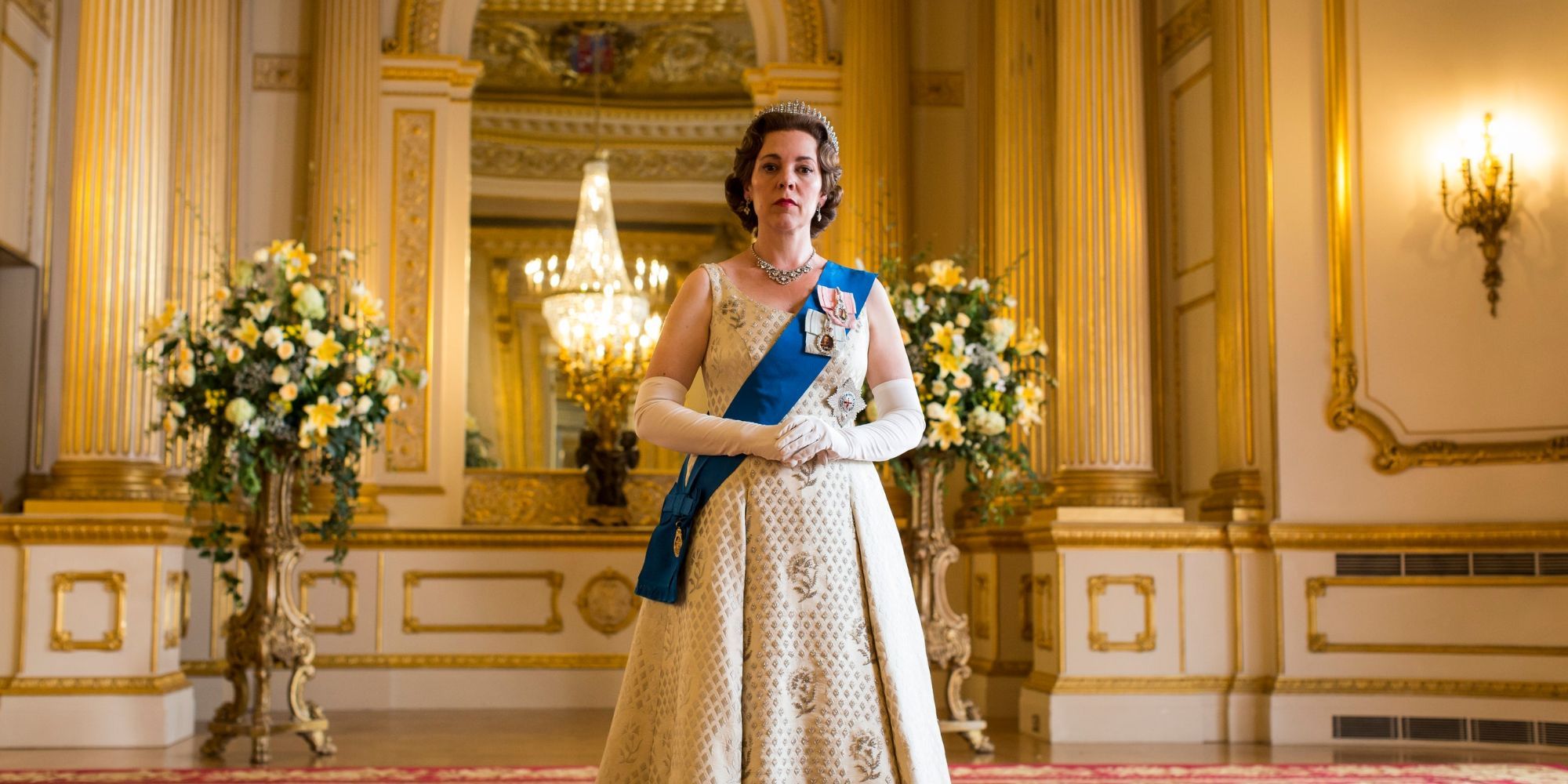 Olivia Colman as Queen Elizabeth II in a white dress in The Crown