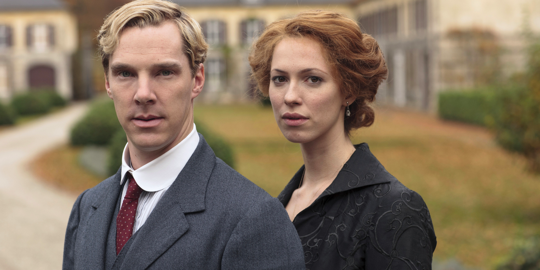 Benedict Cumberbatch and Rebecca Hall stand in front of a large estate in Parade's End