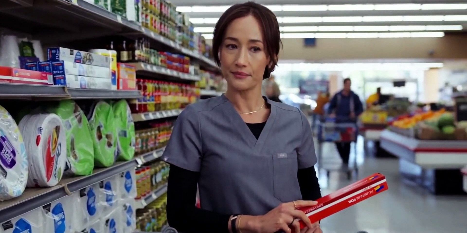 Sarah standing in supermarket in Pivoting.