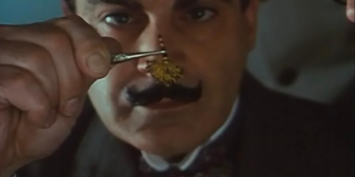 Poirot examining a clue in Death in the Clouds
