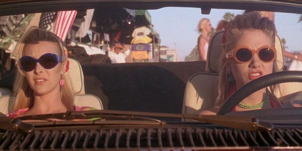 Romy and Michele driving in their car.