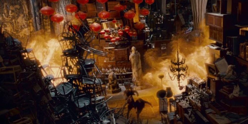 Ron, Hermione and Harry run surrounded by fire in the Room of Requirement in Harry Potter
