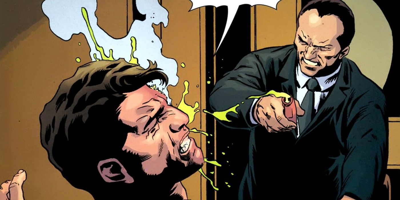 Sal Maroni throws acid in Harvey Dent's face in DC comics.