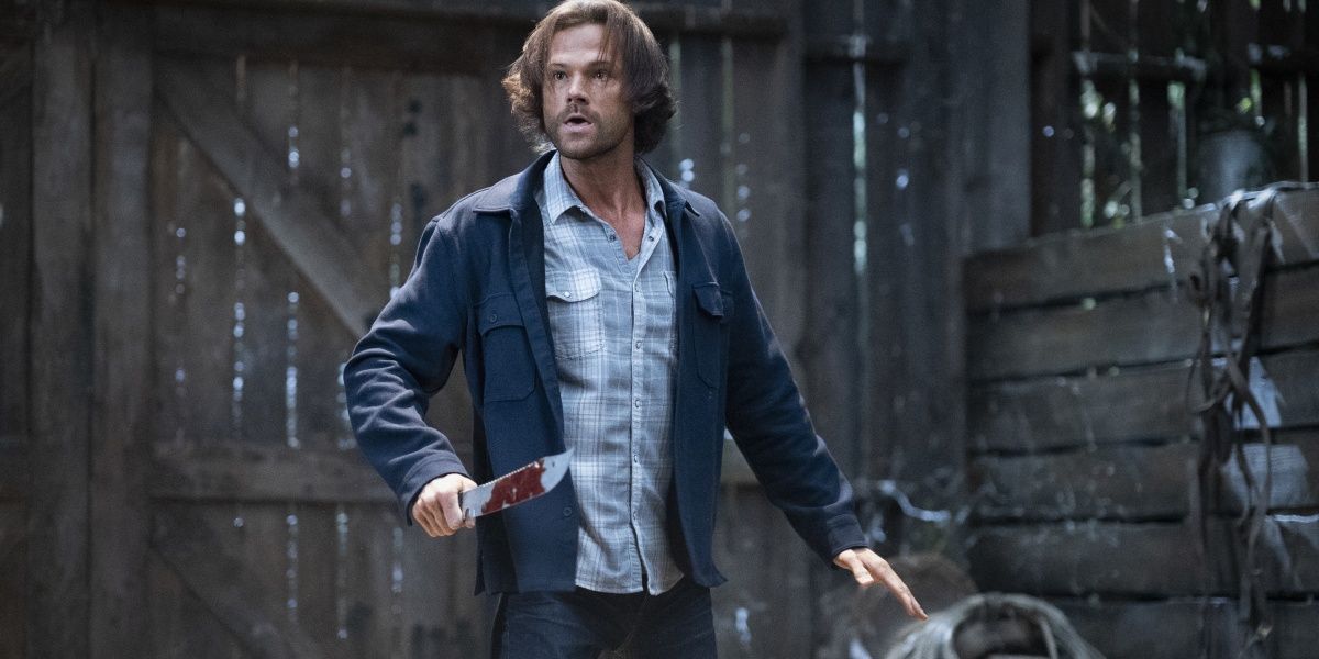 Sam Winchester with a knife in a barn in Supernatural