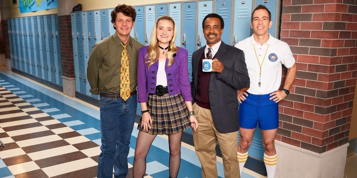 Cast of Schooled posing in the high school hallway