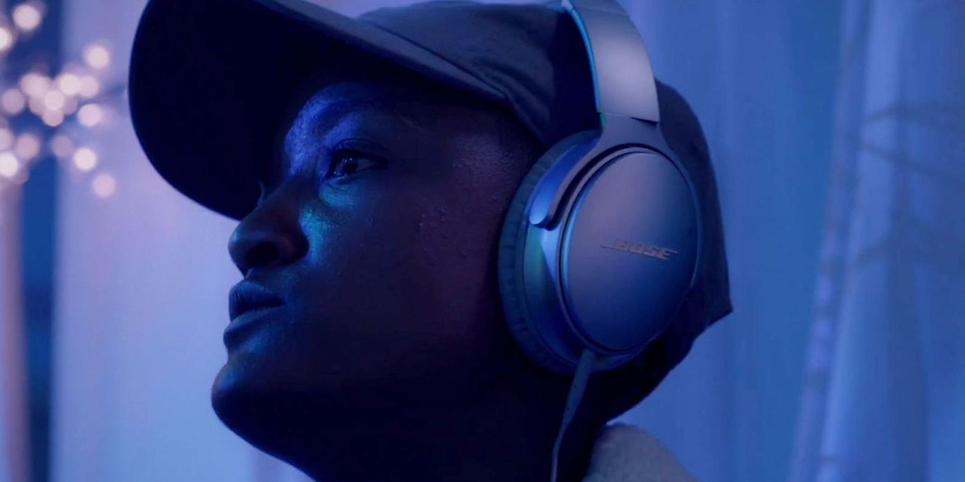 Syd wearing headphones and looking up in Insecure