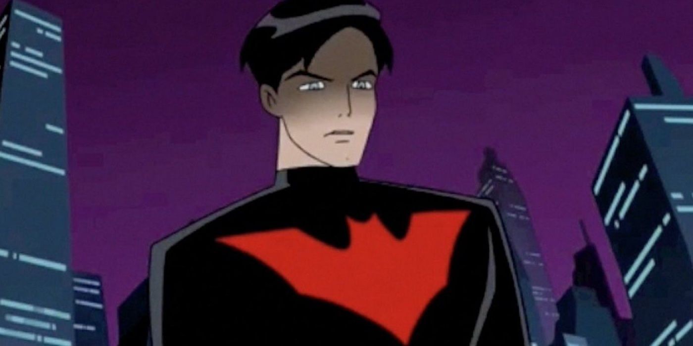 Terry McGinnis unmasked in his Batsuit standing over Gotham City in Batman Beyond