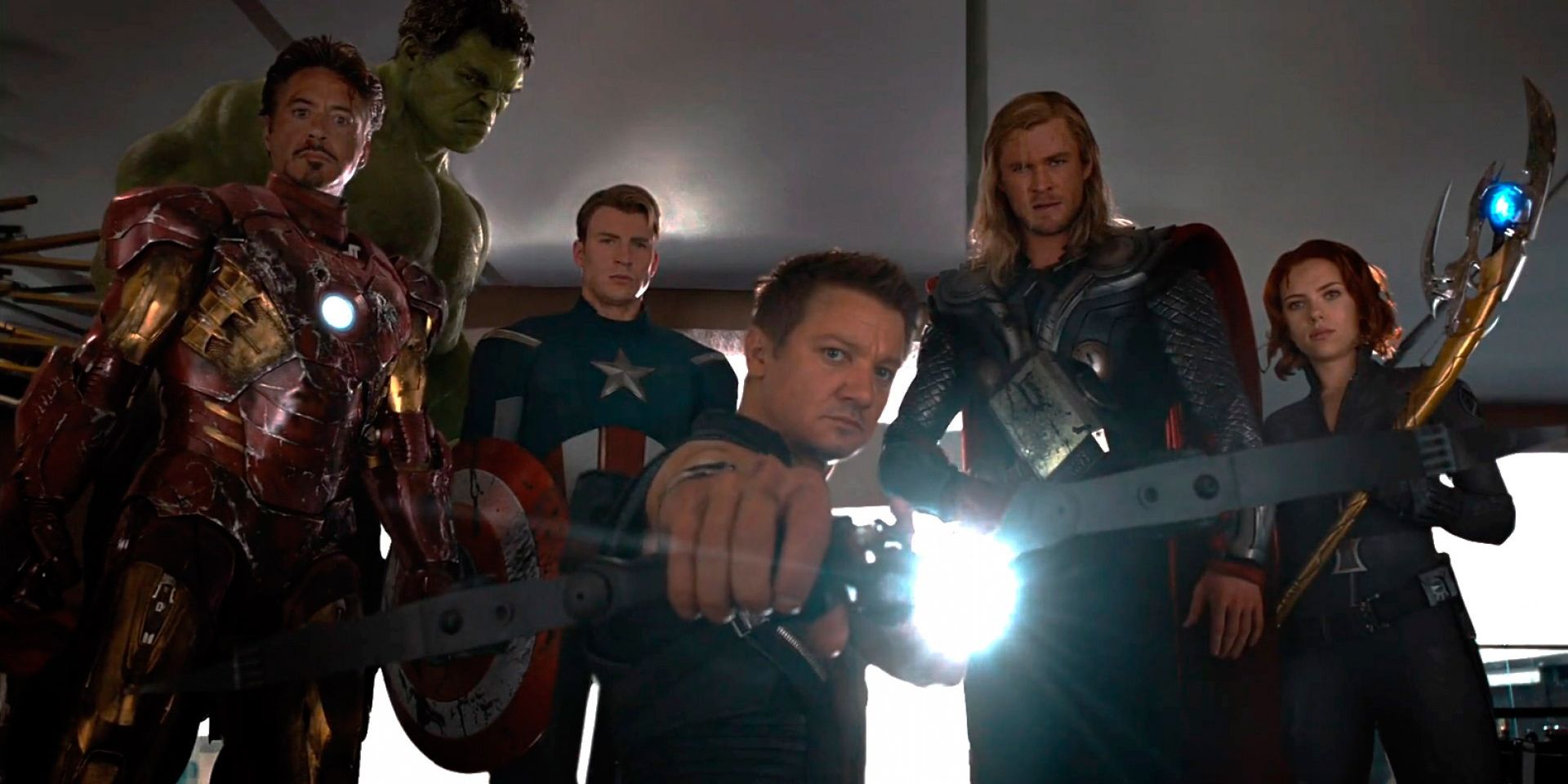 Hawkeye (Jeremy Renner), Thor (Chris Hemsworth), Black Widow (Scarlett Johanssen), Iron Man (Robert Downey Jr.), Hulk (Mark Ruffalo), and Captain America (Chris Evans) stand ready to arrest Loki (Tom Hiddleston)
